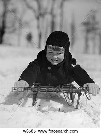 Stock Photography - 1920 1920S 1930 1930S Boy On Sled Facing Camera . Fotosearch