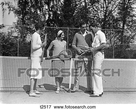 1920 1920S Couples Doubles Tennis Two Girls Two Boys Holding Rackets Standing Near Net On Tennis Court View Large Photo Image Stock Photo - 1920 1920S Couples Doubles Tennis Two Girls Two Boys Holding Rackets Standing Near Net On Tennis Court . Fotosearch