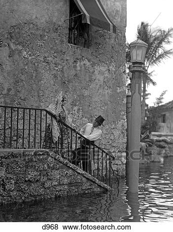 1920 1920S Romantic Couple In Spanish Costumes On Stairs Of Venetian Pool In Coral Gables Florida View Large Photo Image Stock Photo - 1920 1920S Romantic Couple In Spanish Costumes On Stairs Of Venetian Pool In Coral Gables Florida . Fotosearch