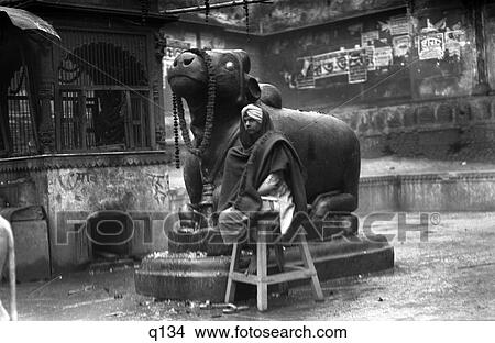 1920S 1920 1930S 1930 Benares India Man In Turban Seated By Statue Of Nandi Scared Hindu God Bull Religion Hinduism View Large Photo Image Picture - 1920S 1920 1930S 1930 Benares India Man In Turban Seated By Statue Of Nandi Scared Hindu God Bull Religion Hinduism . Fotosearch