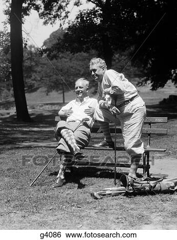1920S 1930S 2 Senior Men At Golf Course Fairway Bench Wearing Knee Length Golf Pants And Argyle Socks View Large Photo Image Stock Photograph - 1920S 1930S 2 Senior Men At Golf Course Fairway Bench Wearing Knee Length Golf Pants And Argyle Socks. Fotosearch