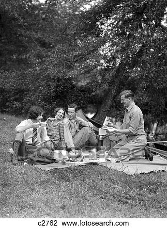 1920S 1930S 4 People 2 Couples Men Women Sitting On Ground Having A Picnic Food Summer View Large Photo Image Stock Image - 1920S 1930S 4 People 2 Couples Men Women Sitting On Ground Having A Picnic Food Summer . Fotosearch
