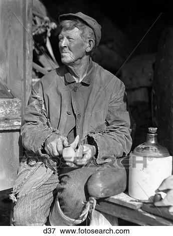 1920S 1930S Elderly Man Weathered Face Sitting Beside Jug Carving Duck Decoy View Large Photo Image Stock Photo - 1920S 1930S Elderly Man Weathered Face Sitting Beside Jug Carving Duck Decoy . Fotosearch