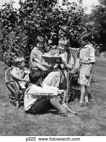 1920S 1930S Grandmother Wicker Chair Reading Book To 4 Grandchildren Boys Girls Woman View Large Photo Image Stock Image - 1920S 1930S Grandmother Wicker Chair Reading Book To 4 Grandchildren Boys Girls Woman . Fotosearch