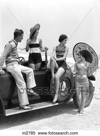 1920S 1930S Man And Three Women In Beach Clothes Or Bathing Suits Posing With Car On Running Board View Large Photo Image Stock Photography - 1920S 1930S Man And Three Women In Beach Clothes Or Bathing Suits Posing With Car On Running Board . Fotosearch