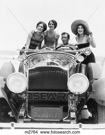 1920S 1930S Man Driving Convertible Touring Car With Three Women In Bathing Suits As Passengers View Large Photo Image Picture - 1920S 1930S Man Driving Convertible Touring Car With Three Women In Bathing Suits As Passengers. Fotosearch