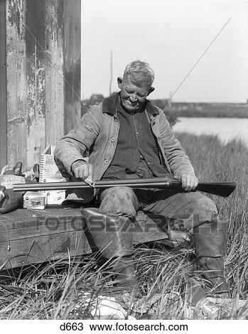 1920S 1930S Senior Man Sitting On Bench Cleaning Duck Hunting Shotgun View Large Photo Image Stock Image - 1920S 1930S Senior Man Sitting On Bench Cleaning Duck Hunting Shotgun . Fotosearch
