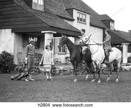 1920S 1930S Two Couples At The Berkshire Hound And Country Club One Couple On Horses The Other Couple Wearing Golf Clothes View Large Photo Image Picture - 1920S 1930S Two Couples At The Berkshire Hound And Country Club One Couple On Horses The Other Couple Wearing Golf Clothes . Fotosearch