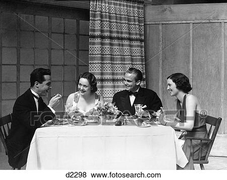 1920S 1930S Two Couples Men Women Formal Attire Eating Dinner View Large Photo Image Stock Photo - 1920S 1930S Two Couples Men Women Formal Attire Eating Dinner . Fotosearch