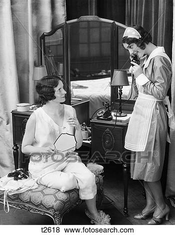 1920s 1930s woman lingerie bedroom answering telephone bureau mirrored maid vanity uniform looks fotosearch clt002