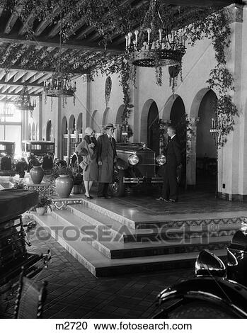 1920S Couple Talking To Salesman In Fancy Automobile Showroom View Large Photo Image Stock Image - 1920S Couple Talking To Salesman In Fancy Automobile Showroom . Fotosearch