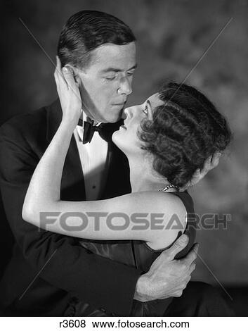 1920S Embracing Romantic Couple About To Kiss Elegant Formal Attire View Large Photo Image Stock Photo - 1920S Embracing Romantic Couple About To Kiss Elegant Formal Attire . Fotosearch