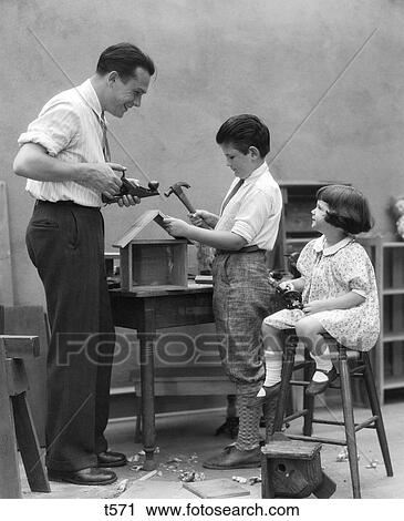 1920S Family Father Carpenter Teaching Son And Daughter To Build A Birdhouse With Woodworking View Large Photo Image Stock Image - 1920S Family Father Carpenter Teaching Son And Daughter To Build A Birdhouse With Woodworking . Fotosearch