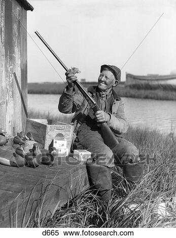 1920S Man Cleaning Shot Gun Duck Decoys Ammunition Box View Large Photo Image Stock Photography - 1920S Man Cleaning Shot Gun Duck Decoys Ammunition Box . Fotosearch