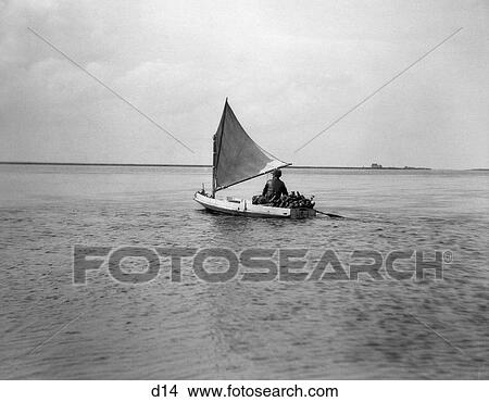 1920S Man In Small Cat Boat Filled With Duck Decoys Going Hunting View Large Photo Image Picture - 1920S Man In Small Cat Boat Filled With Duck Decoys Going Hunting . Fotosearch
