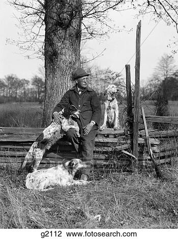 1920S Man & Three Dogs Sitting On Fence His Rifle Is Leaning On The Fence Beside Him View Large Photo Image Stock Image - 1920S Man & Three Dogs Sitting On Fence His Rifle Is Leaning On The Fence Beside Him. Fotosearch