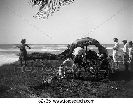 1920S Movie Crew Filming Woman In Grass Skirt Hula Dancing Along Shore View Large Photo Image Stock Photography - 1920S Movie Crew Filming Woman In Grass Skirt Hula Dancing Along Shore . Fotosearch