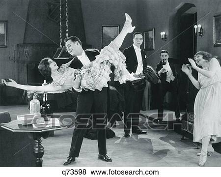 1920S Movie Still Of Wild Party With Woman Flapper Turned Upside-Down In Arms Of Man Dancing View Large Photo Image Stock Photo - 1920S Movie Still Of Wild Party With Woman Flapper Turned Upside-Down In Arms Of Man Dancing . Fotosearch