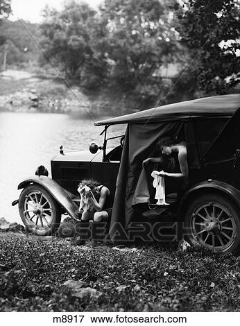 Stock Photo - 1920S Pair Of Women At Car Lakeside Drying Off After Swim . Fotosearch