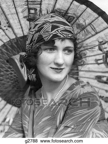 1920S Portrait Of A Woman In Front Of A Japanese Parasol Wearing Pearls And A Silk Print Headband  View Large Photo Image Stock Photo - 1920S Portrait Of A Woman In Front Of A Japanese Parasol Wearing Pearls And A Silk Print Headband . Fotosearch
