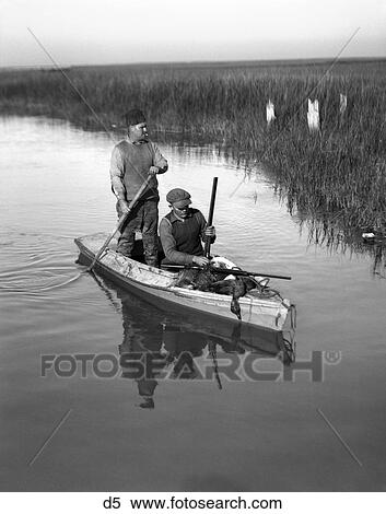 1920S Two Men Duck Hunters With Shotguns In A Skiff Willis Wharf Virginia View Large Photo Image Stock Photography - 1920S Two Men Duck Hunters With Shotguns In A Skiff Willis Wharf Virginia . Fotosearch