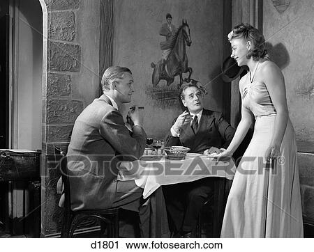 Stock Image - 1930 1930S 1940 1940S 2 Men Eating Club Restaurant 1 Woman Flirting Table Blonde Blond Woman Smoking Cigar Cigars Retro . Fotosearch