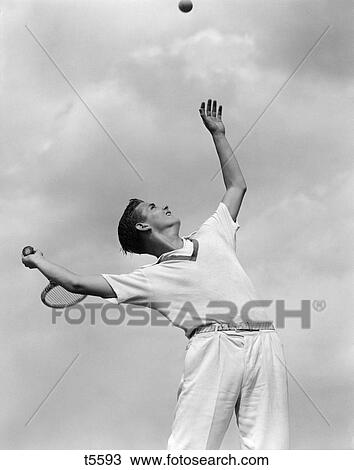 1930 1930S 1940 1940S Boy Tennis Player Throwing Ball In Air For A Serve With Tennis Racket In Hand View Large Photo Image Stock Image - 1930 1930S 1940 1940S Boy Tennis Player Throwing Ball In Air For A Serve With Tennis Racket In Hand . Fotosearch