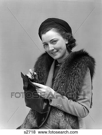 Stock Photo - 1930 1930S 1940 1940S Woman Dressed Up With Fur Jacket Holding Purse With Money . Fotosearch