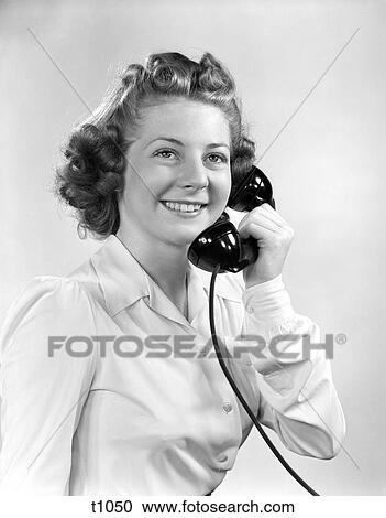 Stock Image - 1930 1930S 1940 1940S Young Girl Talking On Telephone Smiling . Fotosearch