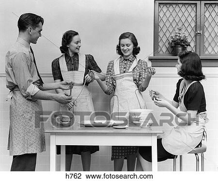 1930 1930S 1940S 1940 Women 1 Man Aprons In Kitchen Pulling Taffy View Large Photo Image Stock Image - 1930 1930S 1940S 1940 Women 1 Man Aprons In Kitchen Pulling Taffy . Fotosearch