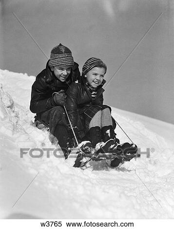 1930 1930S Boy And Girl Going Down Hill On Sled Outside In Snow View Large Photo Image Stock Photography - 1930 1930S Boy And Girl Going Down Hill On Sled Outside In Snow . Fotosearch
