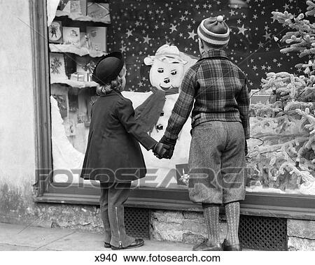 1930 1930S Boy And Girl Holding Hands Looking At Decorated Christmas Window View Large Photo Image Stock Image - 1930 1930S Boy And Girl Holding Hands Looking At Decorated Christmas Window . Fotosearch