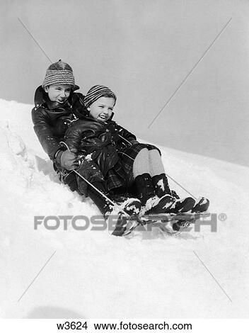 Picture - 1930 1930S Boy And Girl Sledding Downhill . Fotosearch