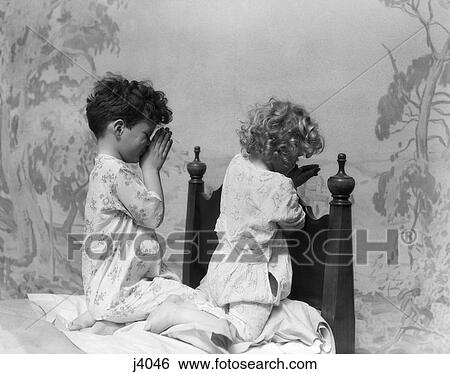 1930 1930S Boy Girl At End Of Bed In Pajamas Saying Prayers Praying Retro View Large Photo Image Stock Photograph - 1930 1930S Boy Girl At End Of Bed In Pajamas Saying Prayers Praying Retro . Fotosearch