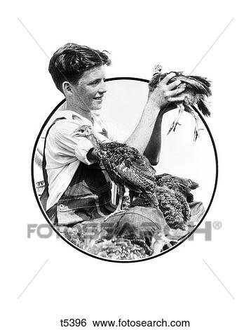 1930 1930S Boy Holding Up Turkey Surrounded By Turkeys View Large Photo Image Stock Photograph - 1930 1930S Boy Holding Up Turkey Surrounded By Turkeys . Fotosearch