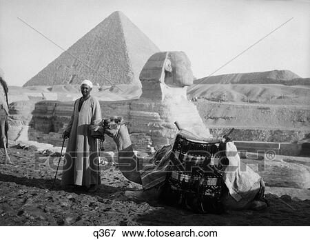 1930 1930S Camel & Driver At The Sphinx & Pyramid Giza Egyptian Man Wearing Arab Dress Rrr Retro View Large Photo Image Stock Photo - 1930 1930S Camel & Driver At The Sphinx & Pyramid Giza Egyptian Man Wearing Arab Dress Rrr Retro . Fotosearch