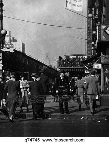 1930 1930S Depression Era Sidewalks Nyc Man Wearing Sandwich Board Ad For Tailor Corner 43Rd St 6Th Ave By Ny Hippodrome Retro View Large Photo Image Stock Photography - 1930 1930S Depression Era Sidewalks Nyc Man Wearing Sandwich Board Ad For Tailor Corner 43Rd St 6Th Ave By Ny Hippodrome Retro. Fotosearch