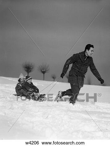 Stock Photograph - 1930 1930S Father Pulling Children On Sled In Snow . Fotosearch
