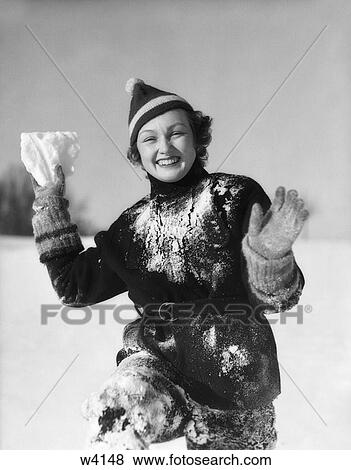 Stock Photo - 1930 1930S Girl Covered In Snow Smiling Holding Snow Arms Out. Fotosearch