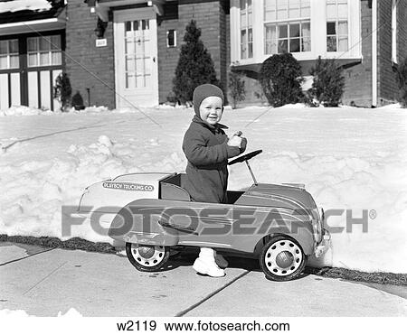 1930 1930S Little Boy Playing In Toy Car Outside In Snow Holding Snowball View Large Photo Image Stock Photo - 1930 1930S Little Boy Playing In Toy Car Outside In Snow Holding Snowball . Fotosearch