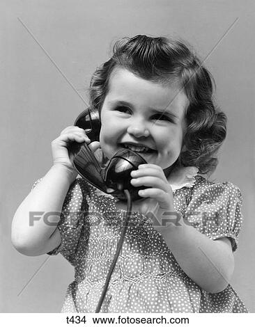 1930 1930S Little Girl Smiling Showing Dimples Talking On Telephone View Large Photo Image Picture - 1930 1930S Little Girl Smiling Showing Dimples Talking On Telephone . Fotosearch