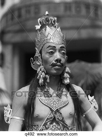 1930 1930S Man Male Javanese Dancer In Costume Portrait Crown Earrings Makeup Fake Moustache Eyebrows Java Indonesia Rrr Retro View Large Photo Image Stock Image - 1930 1930S Man Male Javanese Dancer In Costume Portrait Crown Earrings Makeup Fake Moustache Eyebrows Java Indonesia Rrr Retro. Fotosearch