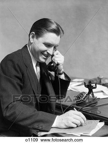 Stock Photo - 1930 1930S Man On Telephone In Office Writing . Fotosearch