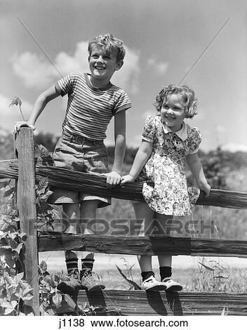 1930 1930S Retro Children Standing On Wooden Fence Smiling View Large Photo Image Stock Photo - 1930 1930S Retro Children Standing On Wooden Fence Smiling . Fotosearch