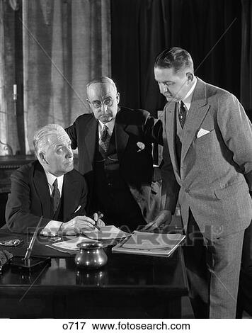 Stock Photo - 1930 1930S Retro Men Desk Meeting Business . Fotosearch