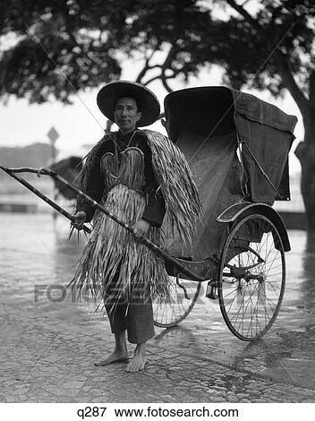 1930 1930S Rickshaw Riksha Jinriksha Coolie In Rain Coat Made Of Grass Straw Pedicab Taxi Transportation Worker Hong Kong Worker View Large Photo Image Stock Photo - 1930 1930S Rickshaw Riksha Jinriksha Coolie In Rain Coat Made Of Grass Straw Pedicab Taxi Transportation Worker Hong Kong Worker. Fotosearch