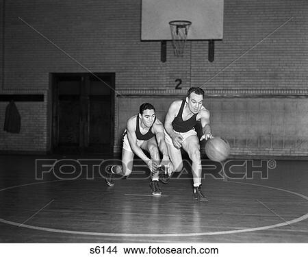 1930 1930S Two Boys Playing Basketball Inside Court Dribbling Basketball View Large Photo Image Picture - 1930 1930S Two Boys Playing Basketball Inside Court Dribbling Basketball . Fotosearch