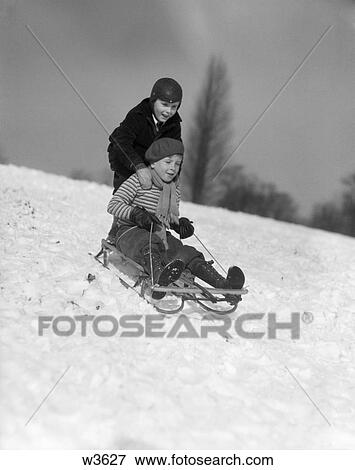 1930 1930S Two Boys Sledding Outside In Snow View Large Photo Image Stock Photo - 1930 1930S Two Boys Sledding Outside In Snow . Fotosearch