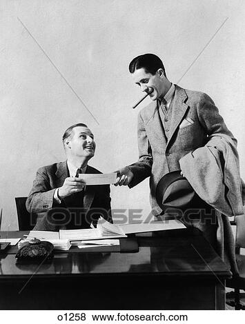 1930 1930S Two Men At Desk In Office One Man With Cigar Exchanging Paper With Office Worker View Large Photo Image Stock Photo - 1930 1930S Two Men At Desk In Office One Man With Cigar Exchanging Paper With Office Worker . Fotosearch