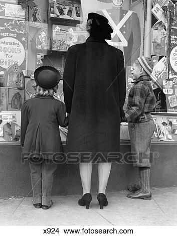 1930 1930S View Of Backs Of Mother Daughter And Son Window Shopping View Large Photo Image Picture - 1930 1930S View Of Backs Of Mother Daughter And Son Window Shopping . Fotosearch